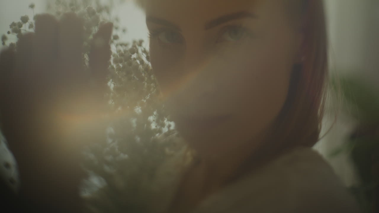 Pensive Woman with Flowers Holding Gypsophila