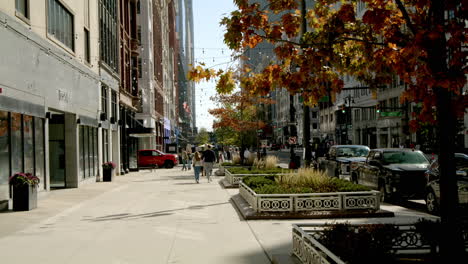 pedestrians walking along woodward avenue in downtown detroit, michigan with video tilting down.