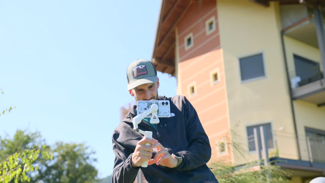 Portrait Of A Person Holding An Insta 360 Flo2 Pro Gimbal Stabilizer. Close-up Medium Shot