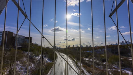 timelapse over the busy don valley parkway from the bloor street viaduct in toronto on a crisp, snowy canada day