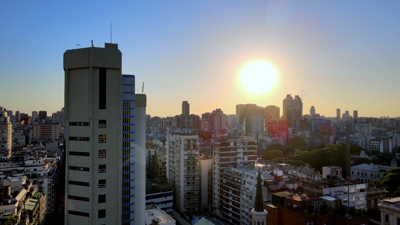 Aerial jib down on Recoleta neighborhood buildings and skyscrapers at golden hour, Buenos Aires