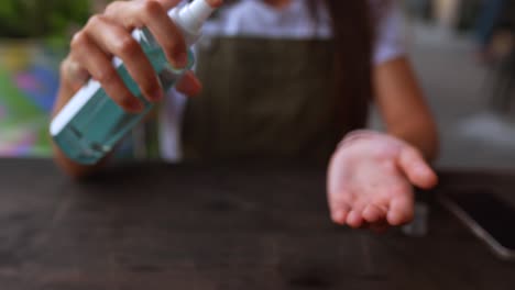 applying hand sanitizer at a restaurant