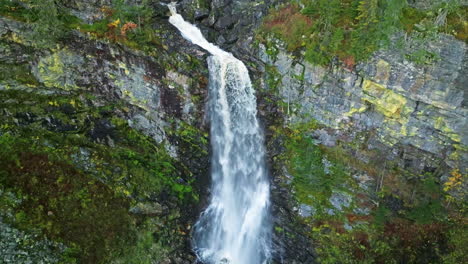 waterfall flowing on mossy cliffs during autumn in sweden