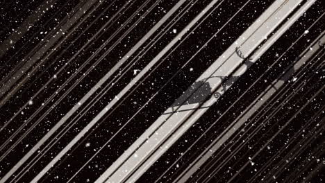 animation of snow falling over santa claus in sleigh with reindeer moving on black background