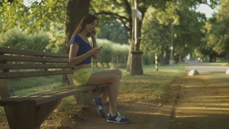 jogging woman setting music on mp3 player before run