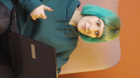 el video vertical de la joven a la que le gusta la aplicación en la computadora portátil es feliz.