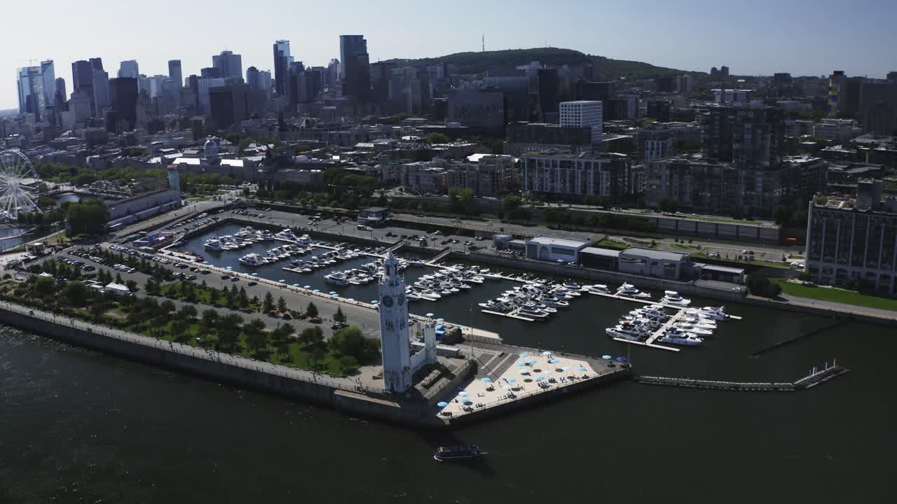 A serene shot of the lighthouse near Montreal's Old Port, standing tall against the river and cityscape. A symbol of guidance and tranquility, perfect for capturing the charm of the waterfront.