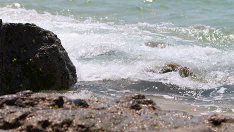 waves crashing on the rocky shore on the beach