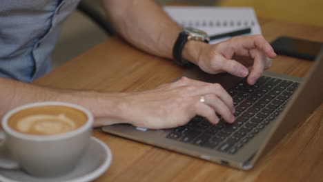 male hands of business man professional user worker using typing on laptop notebook keyboard sit at home office desk working online with pc software apps technology concept close up side view