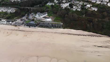 aerial forward shot of carbis bay beach and hotel in cornwall england uk