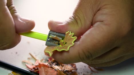 Footage-of-hands-slowly-sharpening-a-pencil-and-some-coloured-pencils-with-a-Wedge-Pencil-Sharpener