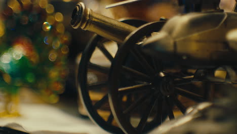 miniature cannon and mini peacock figurine in antique store - rack focus