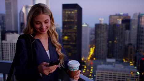 caucasian american businesswoman using smartphone on city rooftop