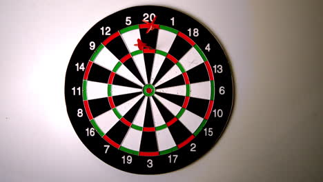 dart hitting the dart board beside another dart