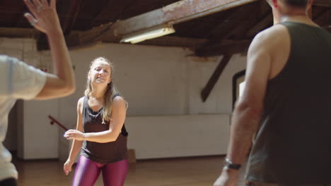 Happy-female-teacher-conducting-dance-class-for-senior-people