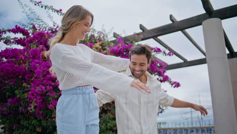 carefree sweethearts joyful date at blossom alley closeup. laughing pair walking