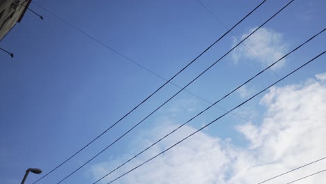 cityscape with power lines and clouds