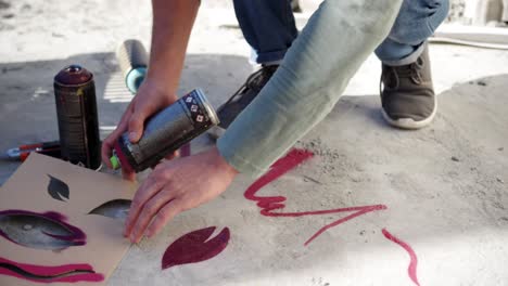 graffiti artist spraying spray paint on cardboard 4k