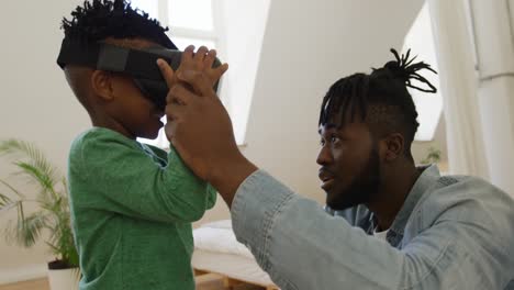 father and son at home using vr