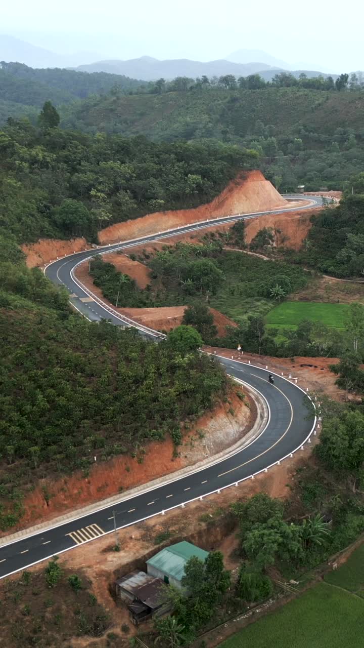 Scenic mountain road winding through a rural landscape