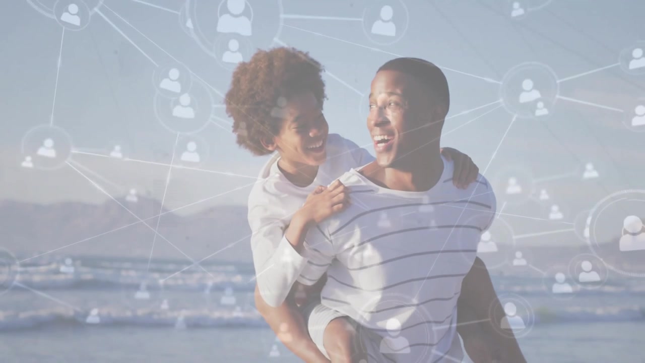 Happy Father Giving Son Piggyback Ride on Beach with Network Overlay