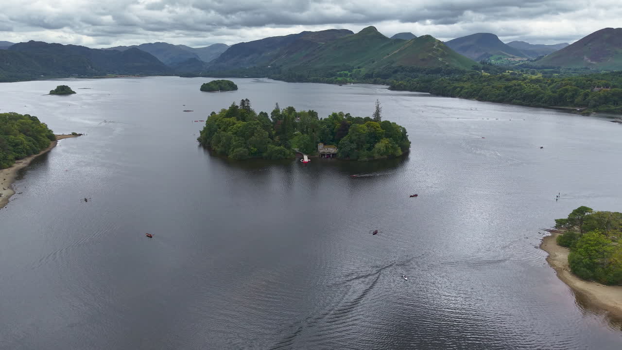 Aerial drone footage flying towards Derwent Isle on Derwent Water near Keswick, England