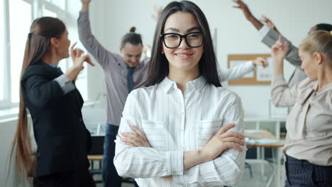confident woman in a busy office setting