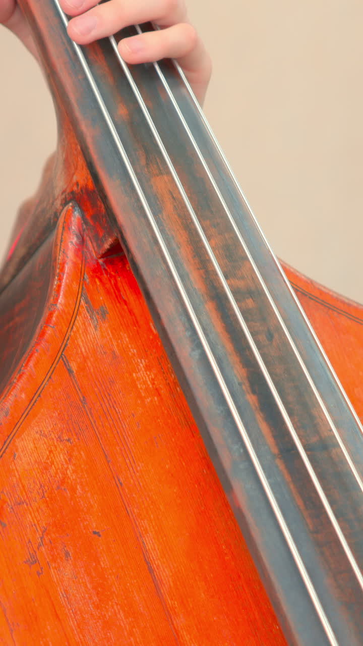 Close-up of Musician Playing Double Bass with Bow and Hand