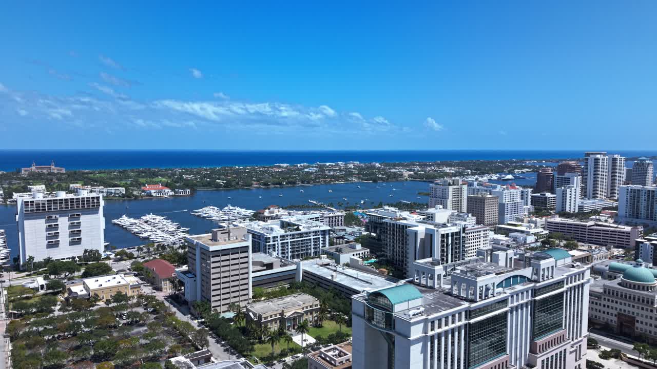 Aerial: downtown West Palm Beach cityscape with skyscrapers during the day in Florida, USA, push in drone shot