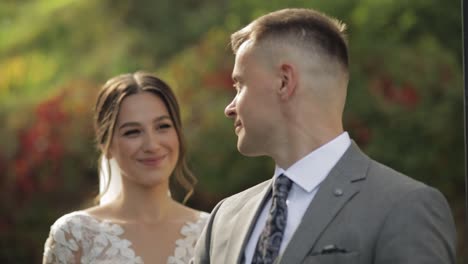 lovely newlyweds caucasian bride embracing groom in park making kiss, wedding couple family hugging