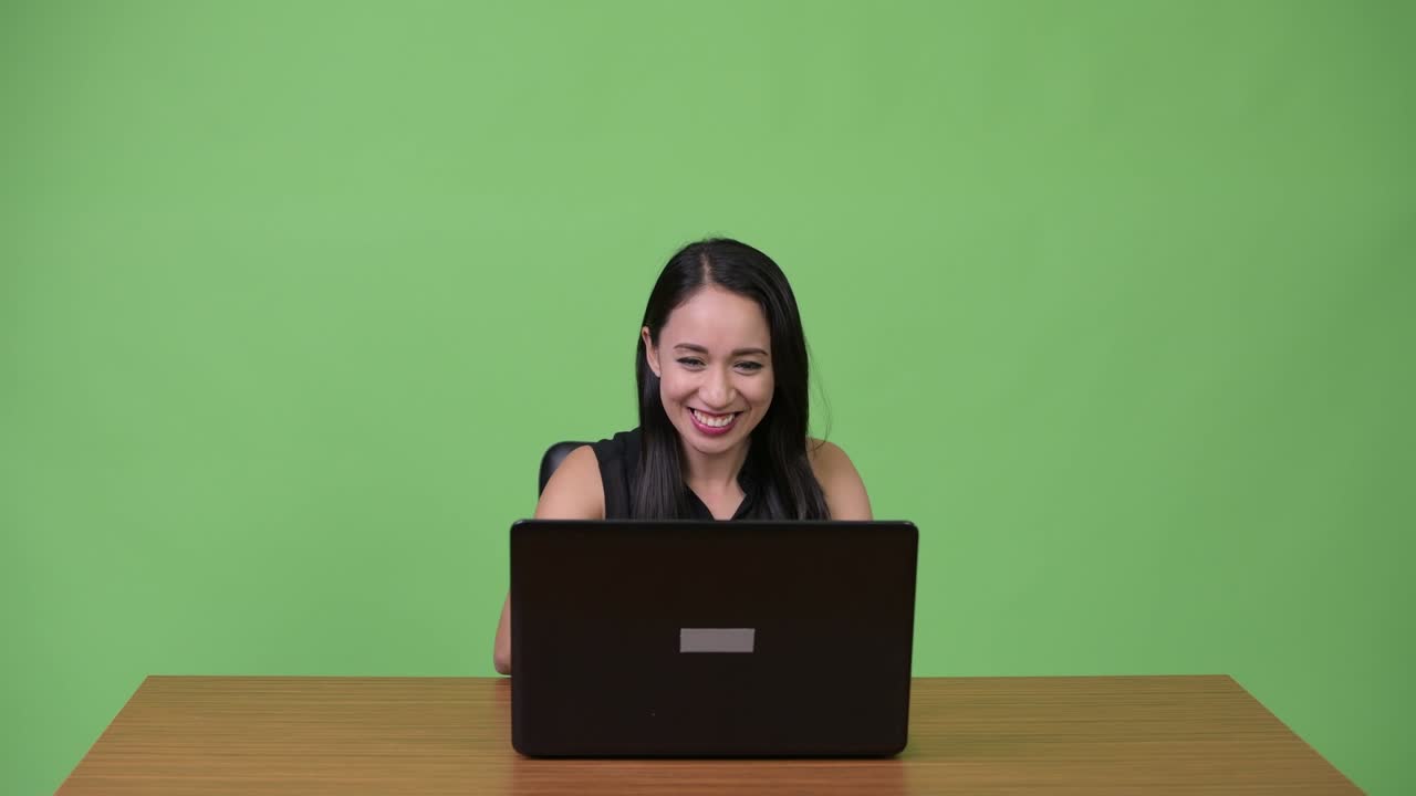 Young Asian businesswoman using laptop with young man getting angry