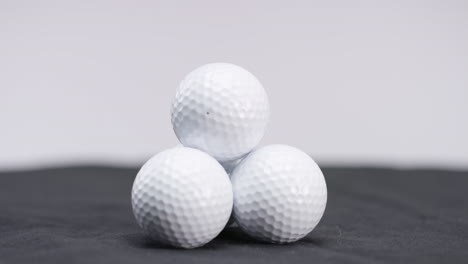 stack-of-white-golf-galls-in-studio