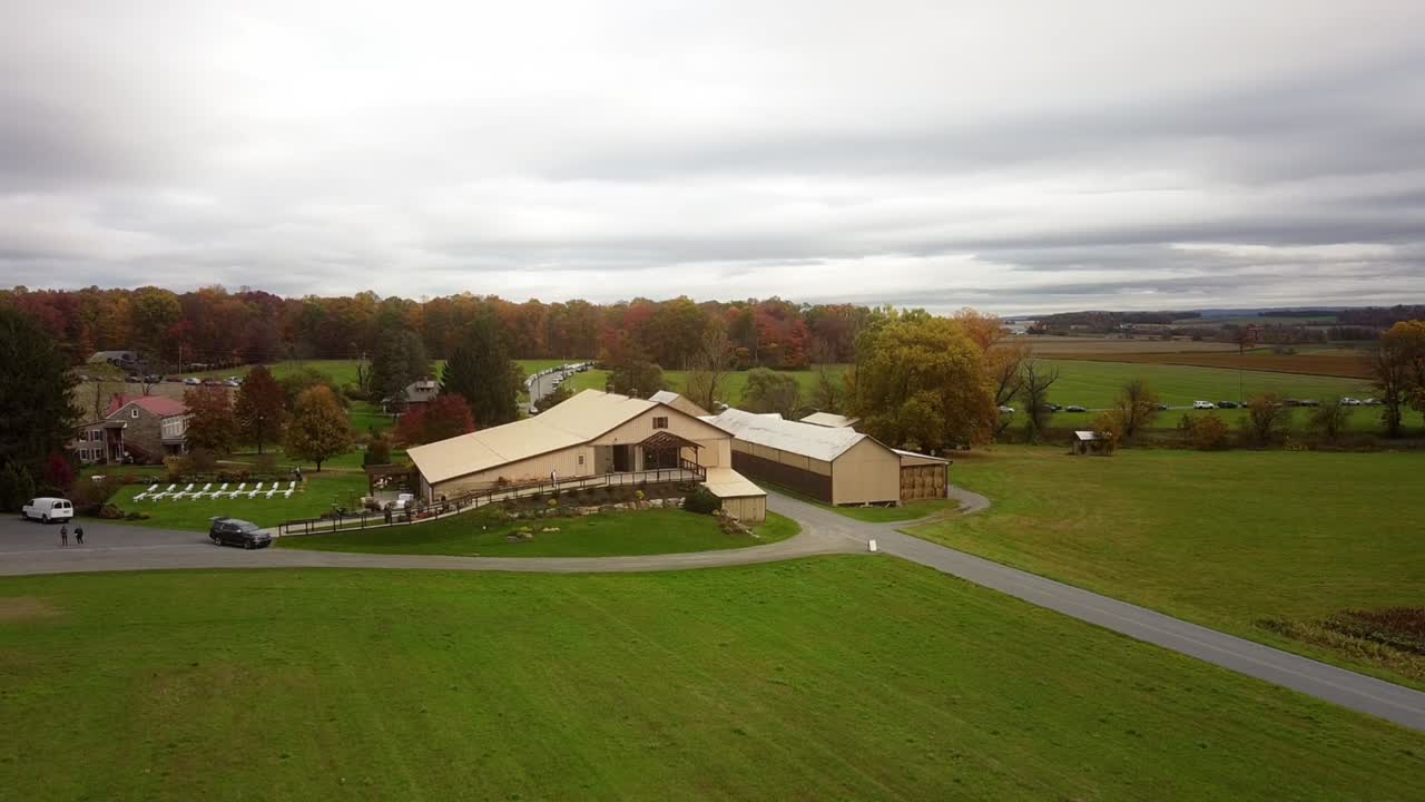 Aerial establishing shot of a converted barn wedding venue in Hamburg, Pennsylvania in the fall