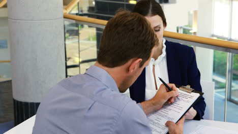 executive taking sign of colleague on document 4k