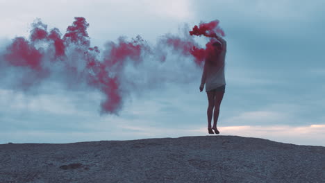 Red-smoke-bomb,-beach-and-woman-dancing