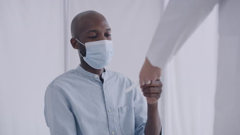 a male doctor taking measures a patient’s
