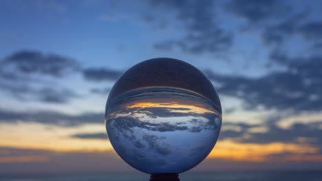 time lapse view of beautiful beach in crystal ball at twilight.