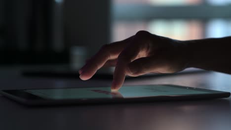 young woman surfing digital tablet at night at home