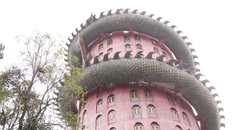 looking-up-at-buddhist-Dragon-Temple,-Wat-Sam-Phran-near-Bangkok-Thailand