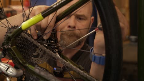 Close-up-of-male-bike-mechanic-tightens-up-a-rear-brake-calliper