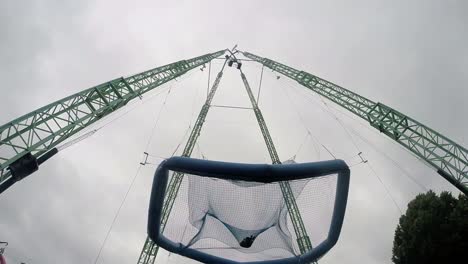 man jumps into a giant hanging trampoline at the amusement park-1