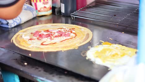 vendor preparing crepes with various toppings