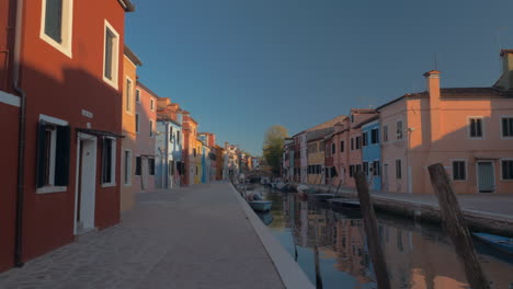 peaceful and picturesque view of burano island with colored houses and canal