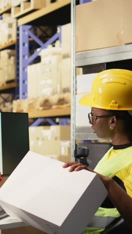 vertical video african american female verifying the shipment details on awb labels