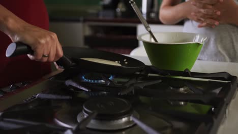 Mother-and-daughters-cooking-crepes-together