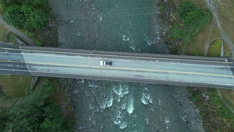 descending over coquihalla river bridge near hope in british columbia, canada. aerial topdown shot