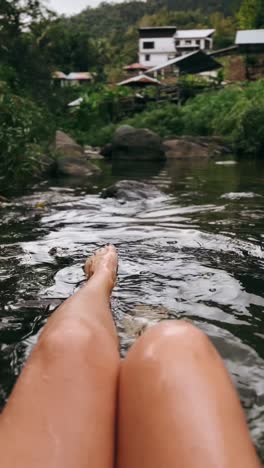 relaxing by a stream in a village