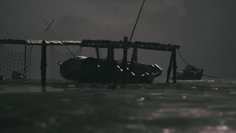 dark waters feature a small boat docked under a wooden pier at night