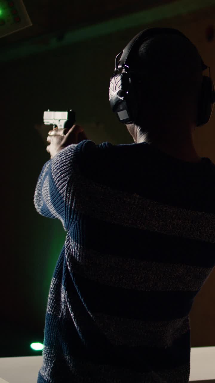 Vertical video Employee loading firearms for shooting range company customers