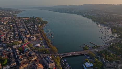 golden summer sunset over zürich, captured by drone with stunning views of the city, lake, river, and iconic churches.